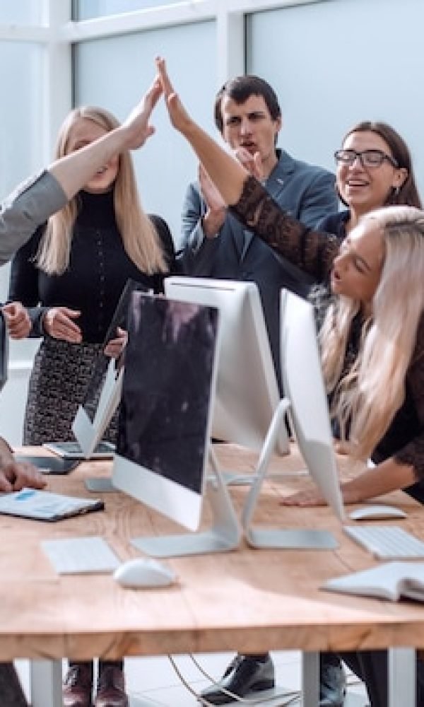 happy-business-team-showing-their-success-workplace_252847-52052